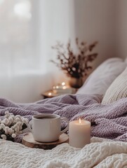 Aromatic morning cup with warm candles relaxing on the bed