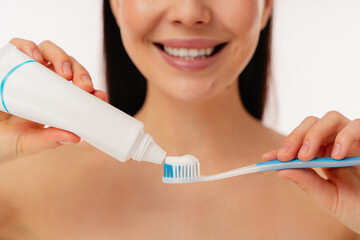Bright and cheerful moment showcasing daily dental care practices, with focus on toothpaste application.
