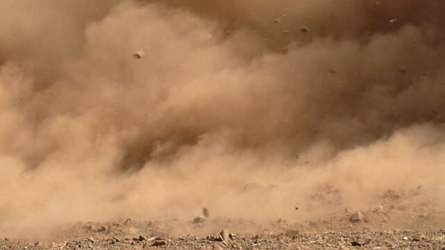 Explosion with flying debris, dust cloud, rock fragments, landslide, Slow-motion, copy space
