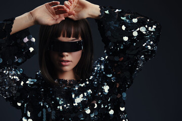 Woman, blindfold, sequinned top a woman in a sparkling sequinned top with a blindfold covering her...