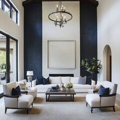 A living room with a blue wall and white furniture. There are two couches, a coffee table, and a potted plant. A chandelier hangs above the coffee table