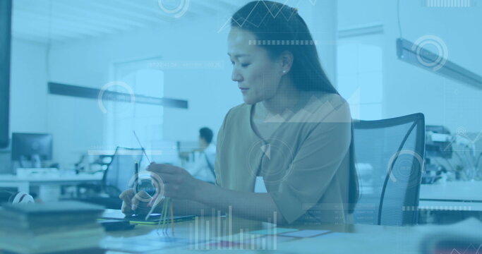 Image of financial data processing over diverse business people in office