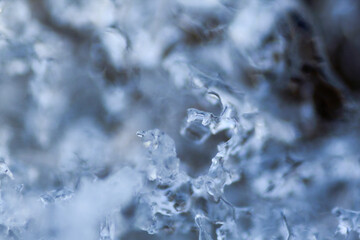 Snow cover near the river, close-up shot of ice