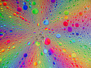 Colorful bubbles create a vibrant abstract pattern under bright light
