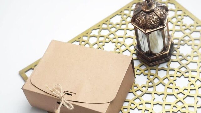 Gift box with Muslim lamp for Ramadan on white table