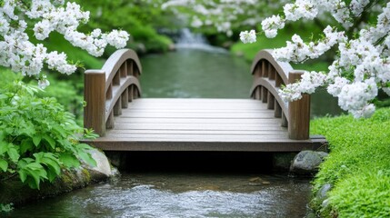 Naklejka premium A small wooden bridge over a clear spring stream, surrounded by blooming trees and lush greenery