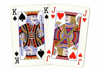 A blackjack or pontoon hand of vintage playing cards isolated on a white background.
