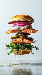 A rustic fish burger featuring a succulent salmon patty, topped with creamy mayonnaise infused with aromatic herbs and complemented by a handful of fresh arugula. A levitating composition 