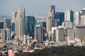 Fototapeta premium Beautiful super wide aerial view of Tokyo, Japan, rooftops and skyscrapers, with skyline and city scenery, seen from the observation deck in a sunny day with a blue sky, Tokyo Metropolitan urban area
