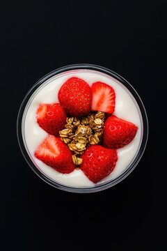 Fresh yogurt topped with vibrant strawberries and crunchy granol
