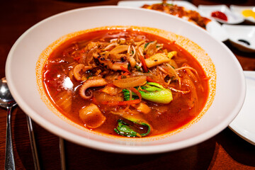 Jjamppong is a Korean noodle soup with red, spicy seafood