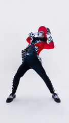 Emotive man, mime artist expressing shock, leaning backward in dynamic pose with bold red and black...