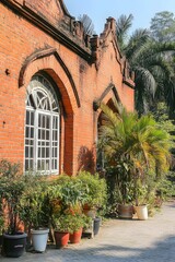 Fototapeta premium Ancient Brick Building Exterior with Lush Greenery