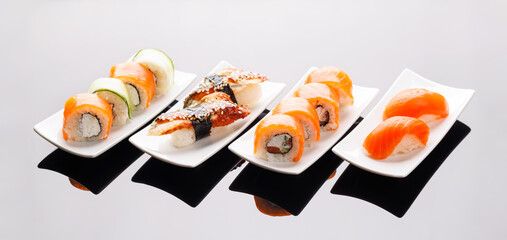 Assorted sushi and maki rolls beautifully arranged on plates