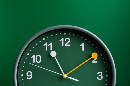 Green clock photo in studio concept of time and efficient use of time