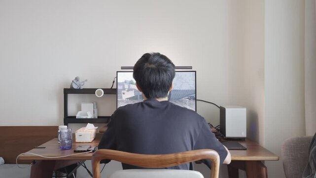 An Asian man playing computer games at home, time-lapse