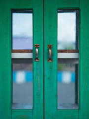 Classic green wooden window with glass