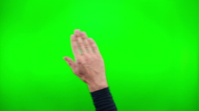 Male hand selects and touches screen, swipes left, right with palm against green screen with chromakey. Demonstration of using smartphone, tablet or touch screen