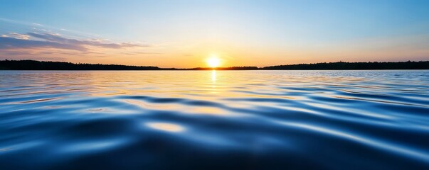 Obraz premium Sunset light dappling on the surface of a quiet fishing lake.