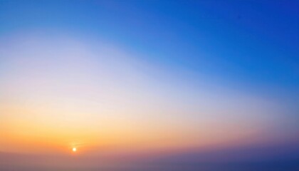 Fototapeta premium soft gradient sunrise sky over distant horizon with warm pastel colors, peaceful serene morning scene