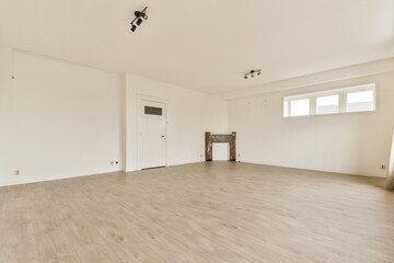 Bright and airy interior featuring pale walls and wooden flooring, creating an ideal space for decoration or renovation.