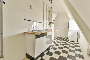 A bright and modern kitchen featuring a sleek design, white cabinetry, and a classic black-and-white checkered floor, ideal for minimalist aesthetics.