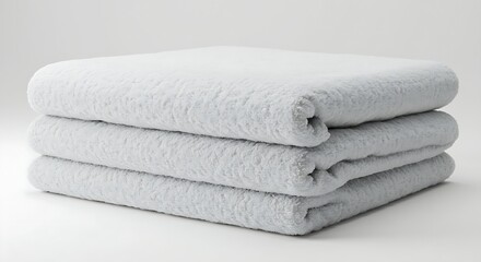 A folded fluffy towel with soft textures against a white backdrop