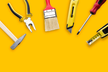set of repair tools on yellow background