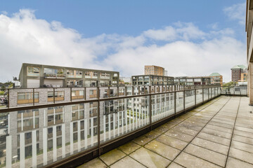 A contemporary balcony overlooking a bustling urban landscape filled with modern buildings and greenery. Ideal for city lovers and architectural enthusiasts.