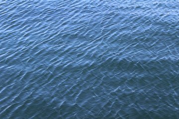 Blue water surface. Water background. Sea surface with small waves.