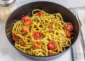 spaghetti with pesto and tomatoes