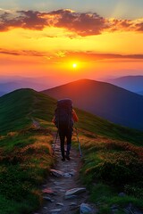 Obraz premium Hiker on mountain path at vibrant sunset, enjoying breathtaking panoramic view