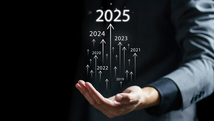 Businessman draws increase arrow graph corporate future growth year 2024 to 2025....