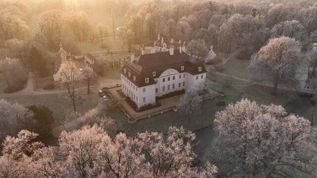 Drone footage of Cottbus pyramid in Branitz park with winter landscape at sunset