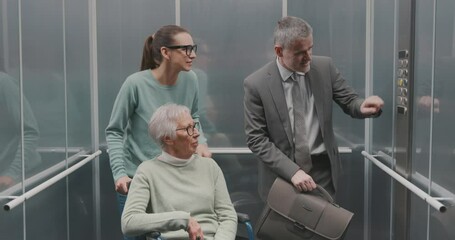 Diverse people talking in the elevator