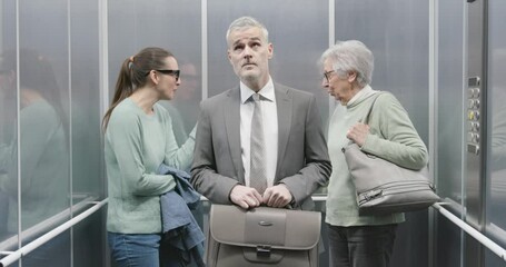 Noisy women talking in the elevator and annoyed man