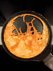 Cooking bunny crepe on frying pan for spring celebration breakfast for maslenitsa or shrove tuesday