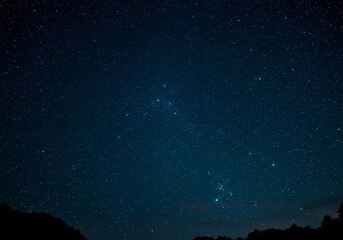 Stunning deep-space background featuring countless bright stars in a dark blue sky.