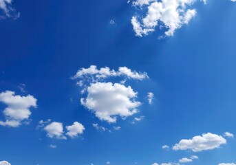 Bright Blue Sky with Wispy White Clouds Floating Peacefully in a Sunny, Open Horizon