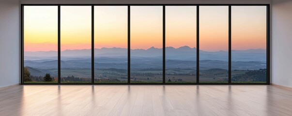Fototapeta premium A spacious room with large glass windows showcasing a stunning sunset view over distant mountains.