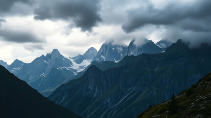 Obraz premium Majestic mountain range with colossal granite peaks rising above a valley, partially covered by a soft morning mist. The light of dawn highlights the cracks and rugged textures of the rock face, while