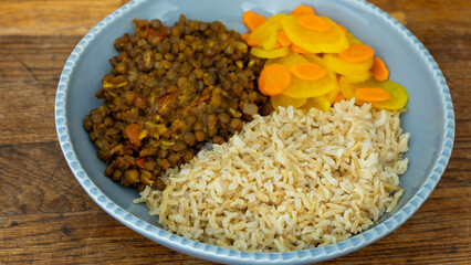 A dish made of sprouted fenugreek seeds, dried Nepali small peas, and jimbu herbs served with rice and pickled radish with turmeric. Healthy vegan food concept. 