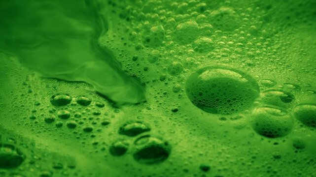 Green Chemical Liquid With Bubbles Closeup
