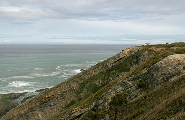 View on the sea and cliffs with a sloped rock formation