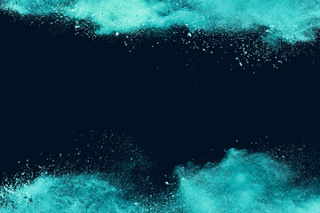 Abstract frame powder splatted background. Green powder explosion on black background copy space. Colored cloud. Colorful dust explode. Paint Holi