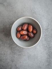 Obraz premium bowl of dates on the table, top view, close-up