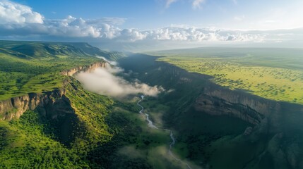 Deep Canyon Landscape and Lush Green Valleys, Winding River with Soft Mist and Rugged Cliffs, Warm Sunlight Glow with Partly Cloudy Sky, Untouched Wilderness Beauty and Majestic Aerial Vista