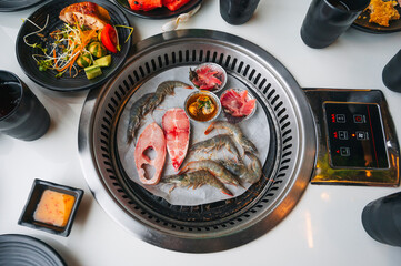 Shrimp and fish are grilled on a stove in buffet in an Asian restaurant in Asia in Vietnam. Fresh seafood is fried