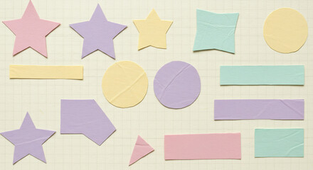 Pastel Paper Shapes A Flat Lay of Cutout Geometric Stars Circles and Rectangles on Beige Textured