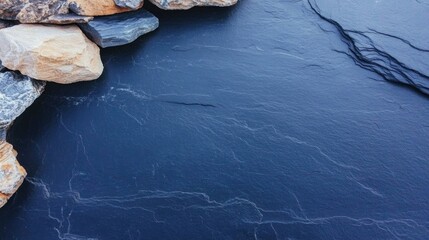 Calm water surface reflecting intricate patterns, bordered by ru